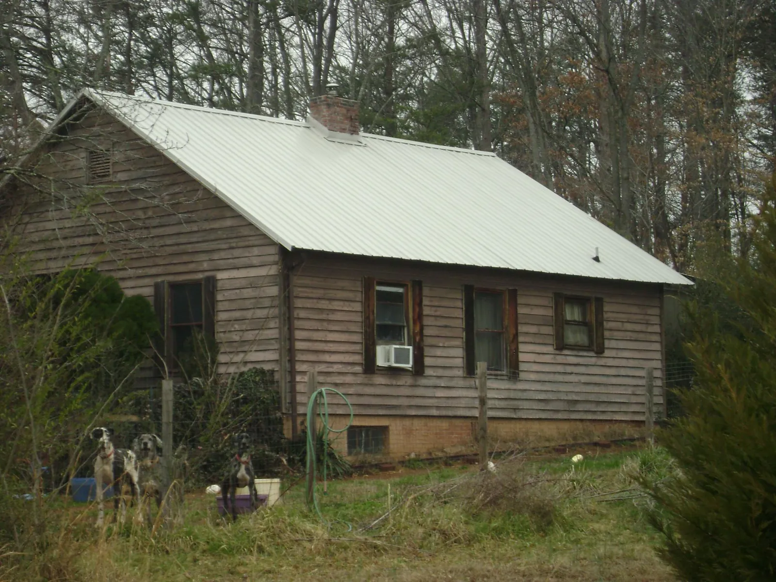 White metal roof on an old wood sided farmhouse, from a Metal Roof Installation job in Hungerford